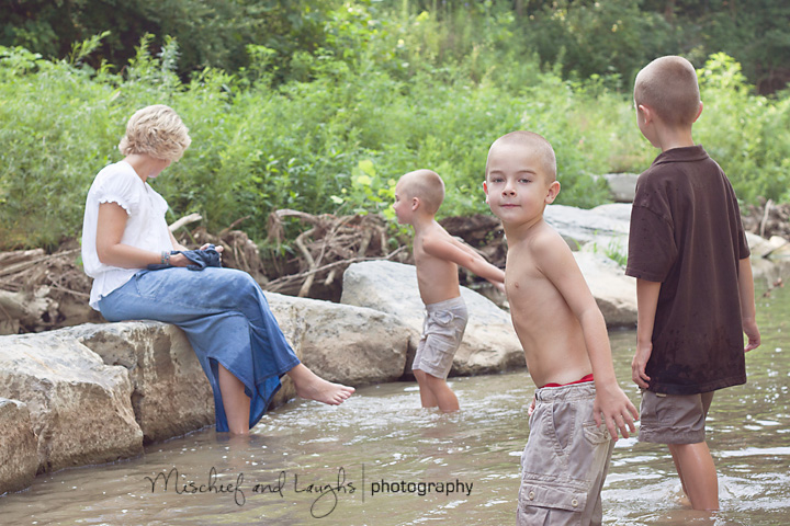 brothers splash in a creek