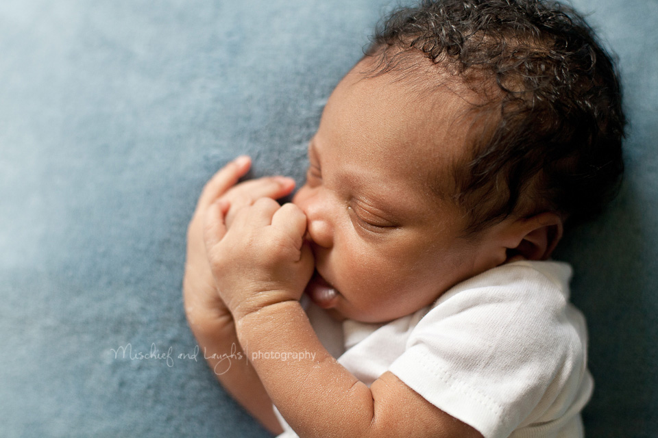 sleeping baby with his fingers in his mouth