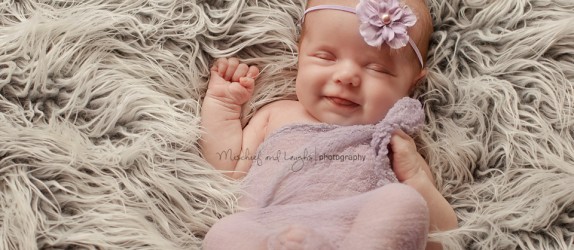 newborn baby in cincinnati smiles for the camera