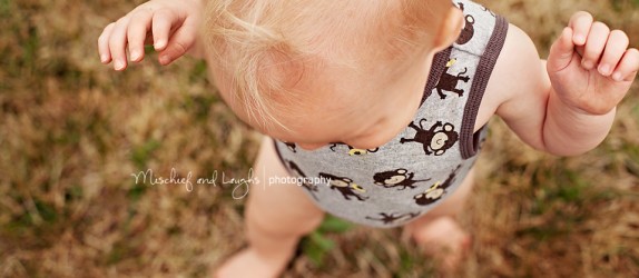 blonde headed baby walking