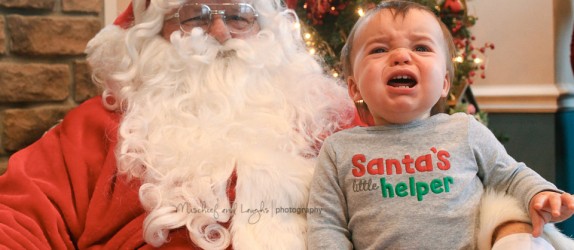 baby cries as he sits on santa's lap for pictures in northern kentucky