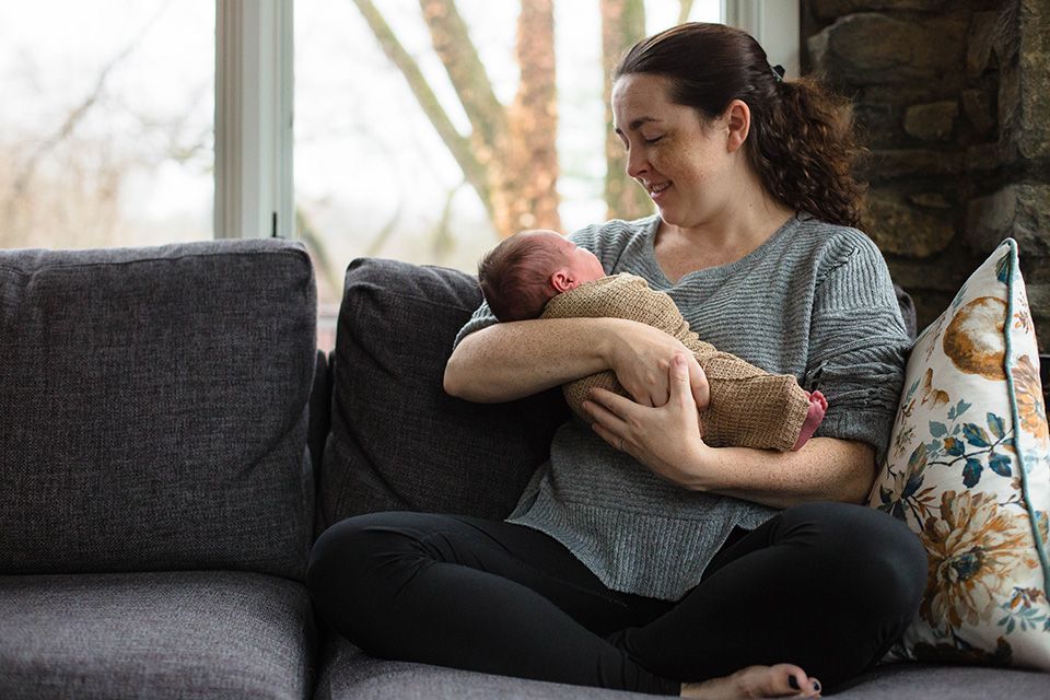 newborn with mom sitting on couch