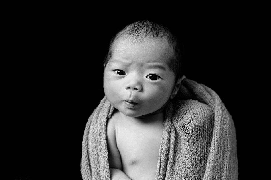 baby makes funny face during newborn pictures