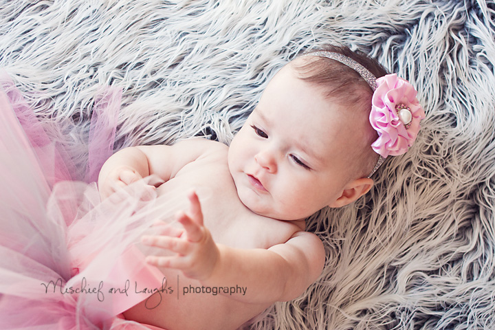 4-month-old is captivated by the tutu her mother put on her for pictures.