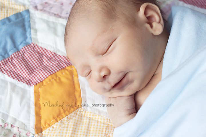 newborn baby gives cincinnati photographer a smile