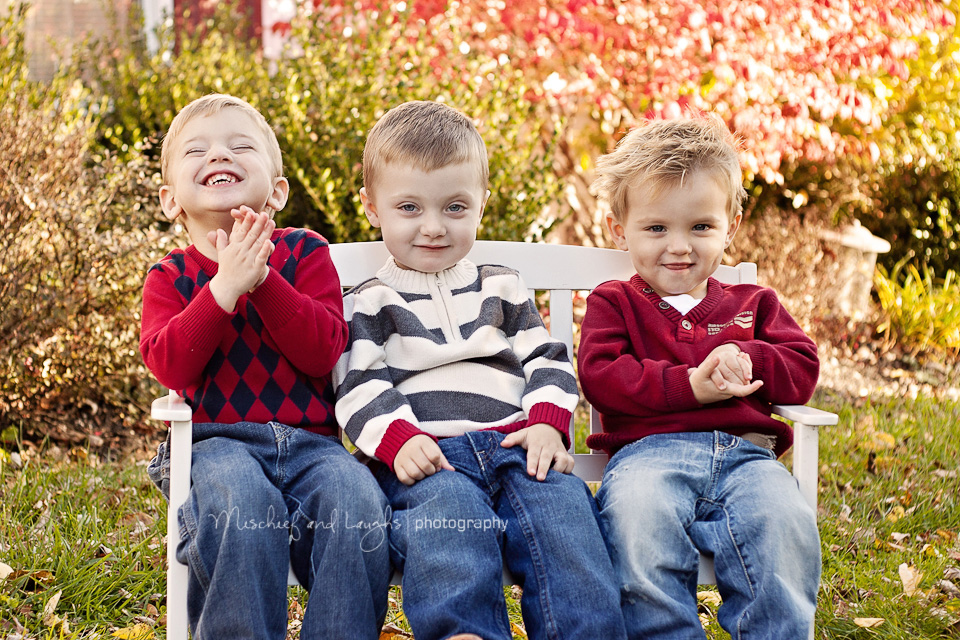 three little boys share a giggle