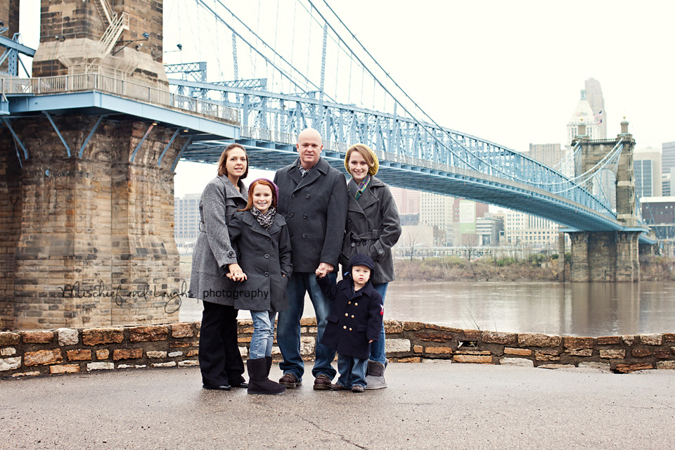 Family poses near the Roebling Bridge
