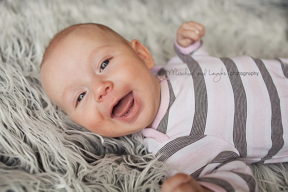 two month old baby with a huge smile
