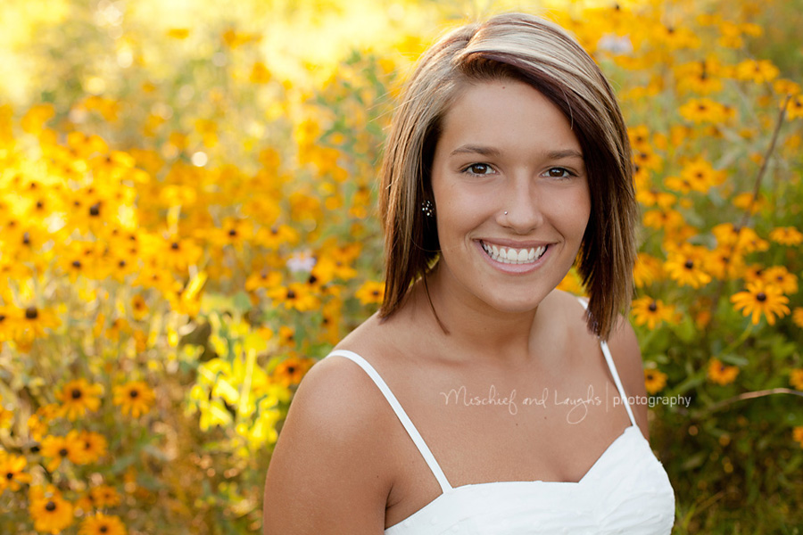 Senior portraits of a pretty girl with yellow flowers