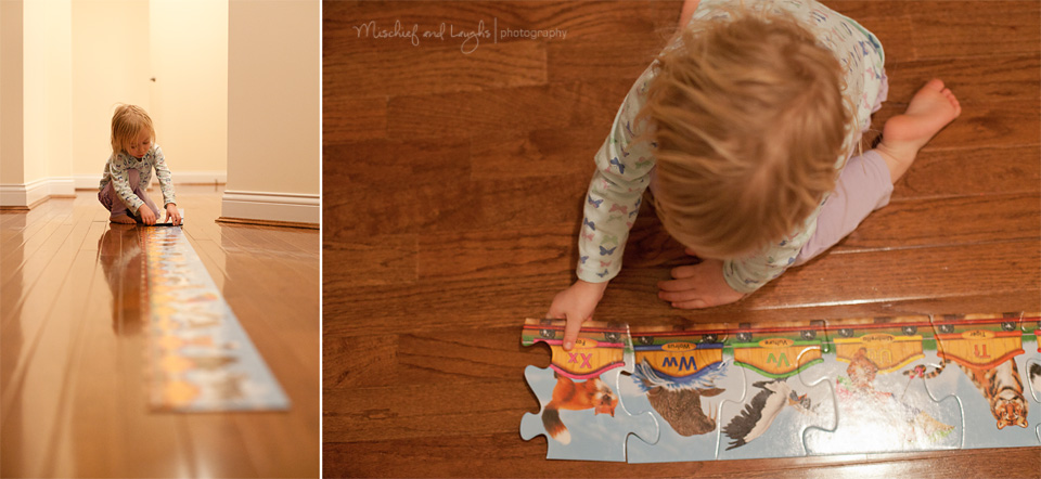 Toddler working a giant puzzle