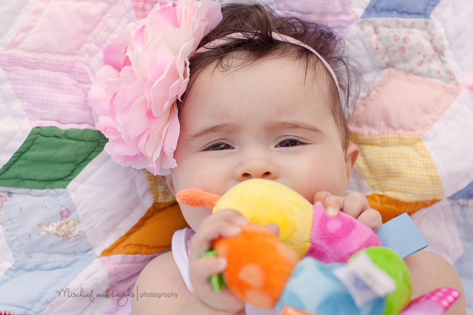 baby chewing on toys