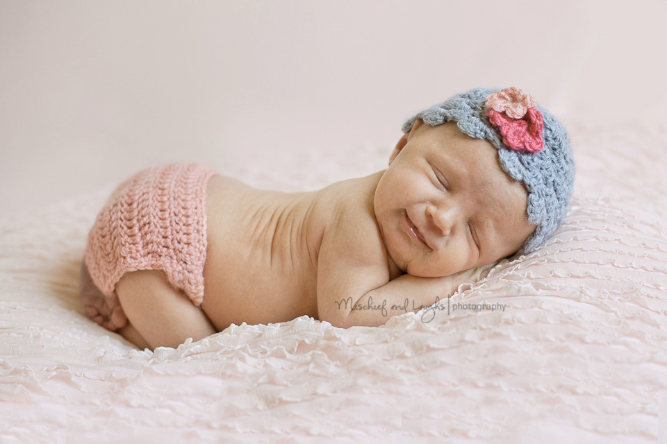 newborn picture with a big baby smile