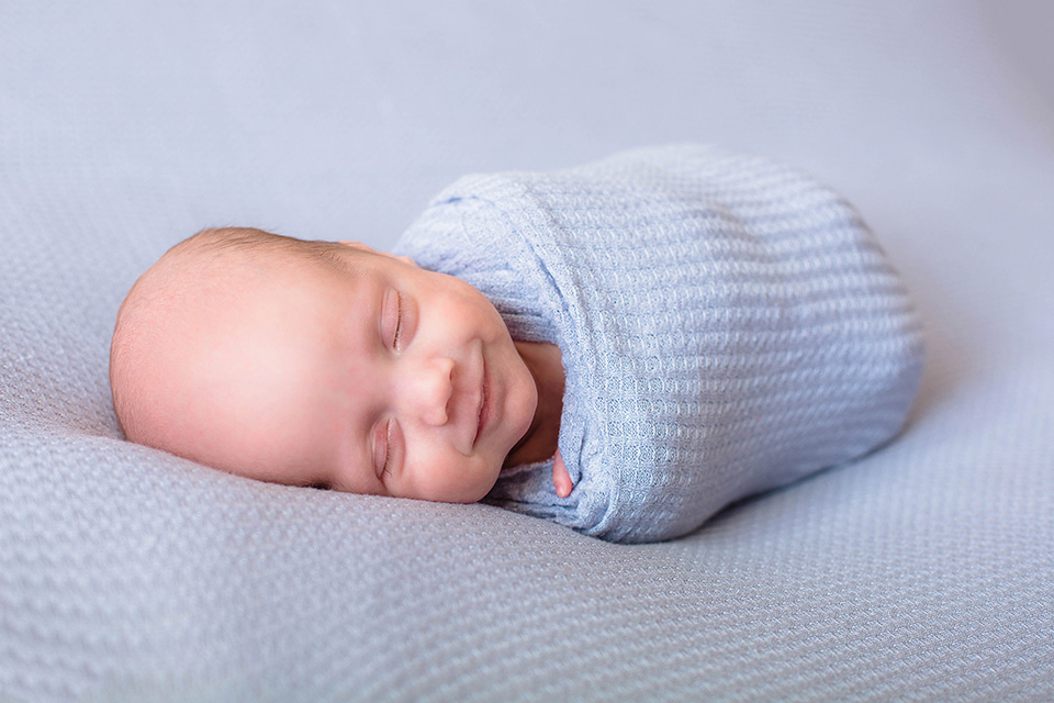 Newborn smiling Swaddle Pictures, Newborn photographer in Canandaigua NY