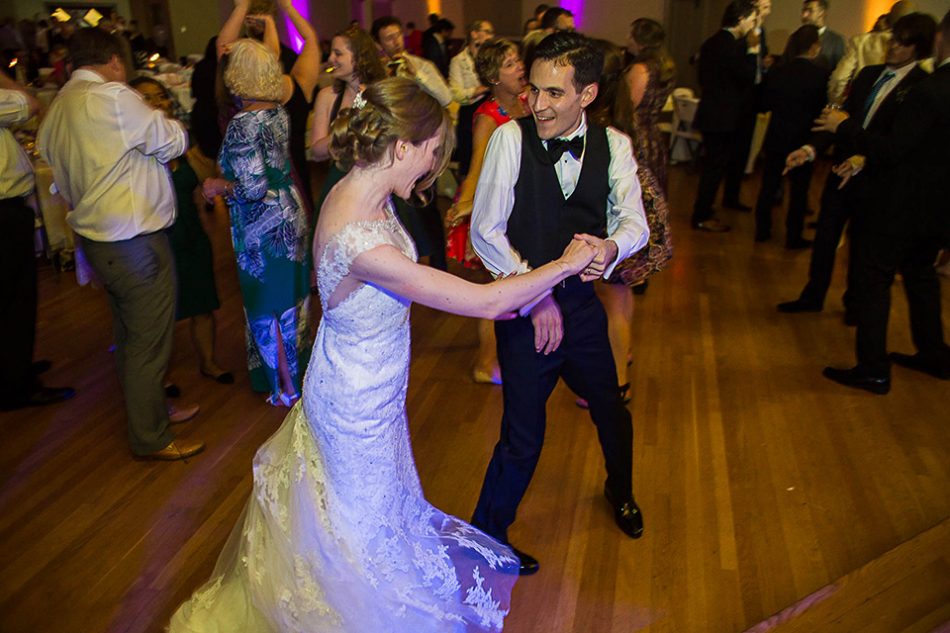 bride and groom dancing together 