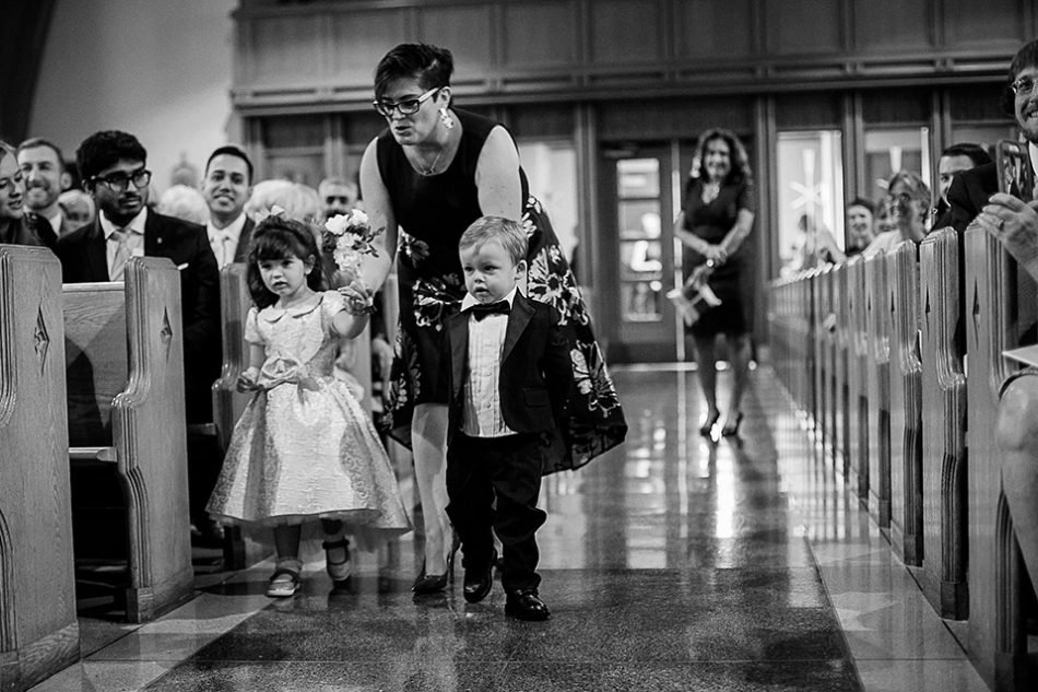 flower girl and ring bearer walk down the aisle together