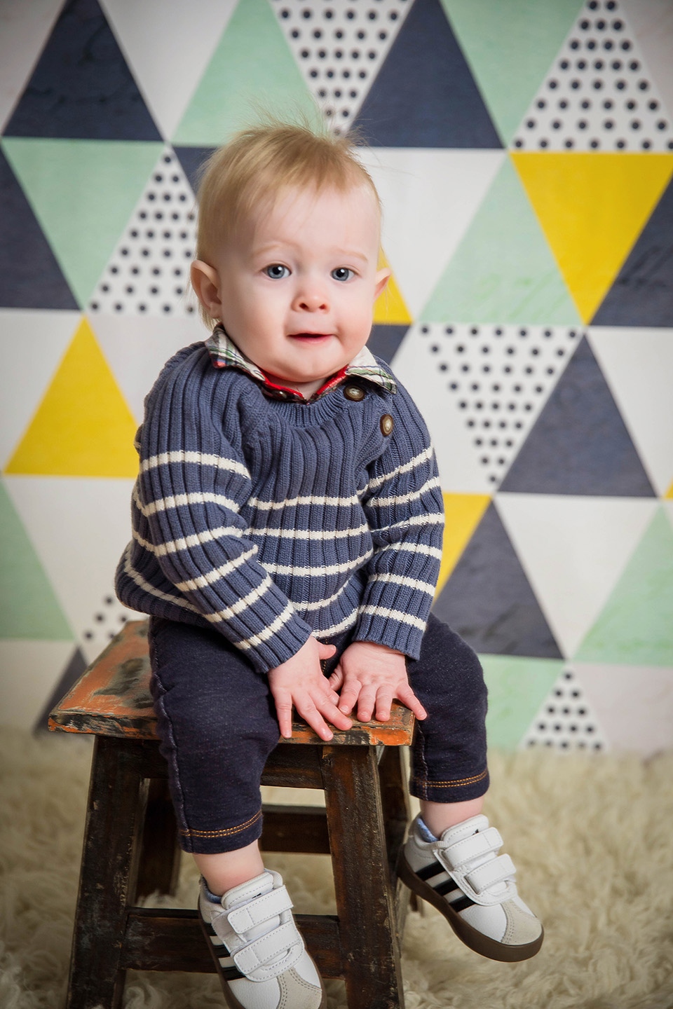 One-year-old boy in a studio session celebrating his first birthday with classic portraits.