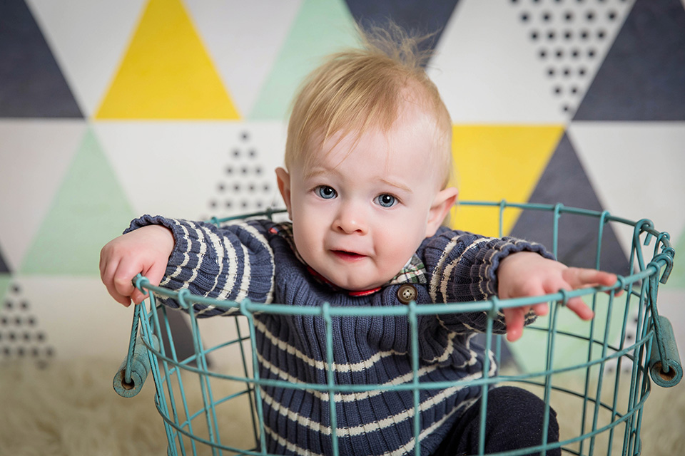 Smiling baby boy looking at the camera during his first birthday photoshoot in Cincinnati.