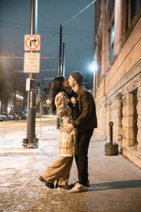 Casual candid shot of a couple celebrating their engagement surprise outside Rhinegeist Brewery.