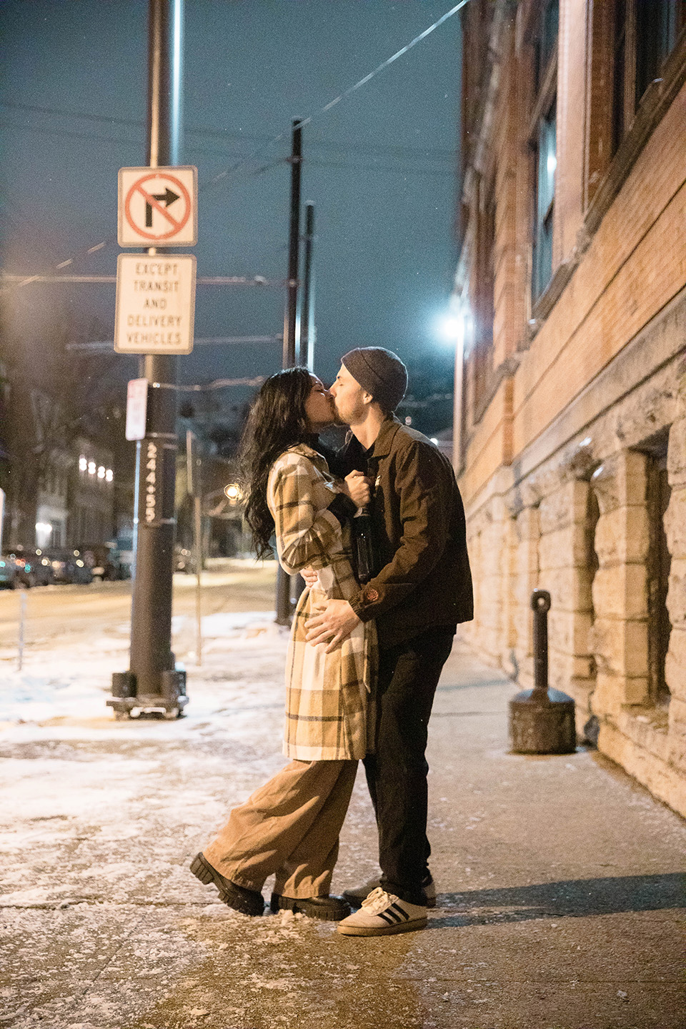 Casual candid shot of a couple celebrating their engagement surprise outside Rhinegeist Brewery.