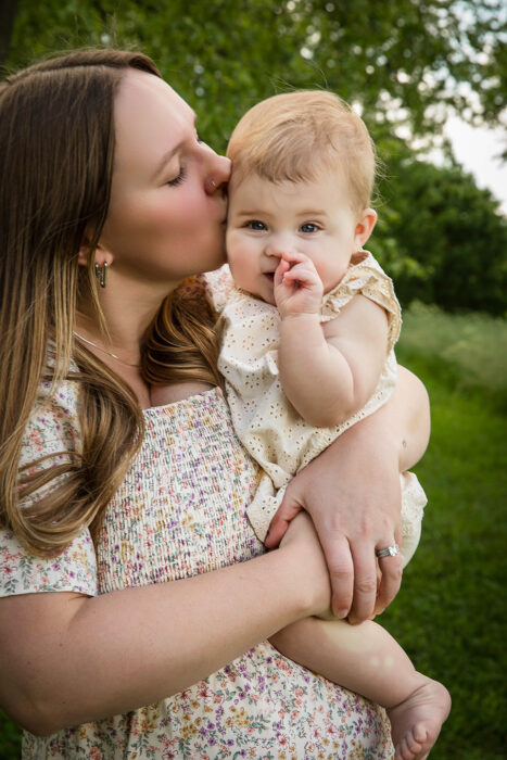 Parents snuggling their infant daughter in a Cincinnati family session