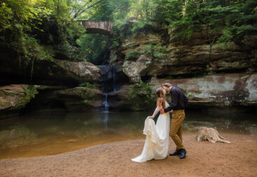 Romantic bride and groom portraits in front of the waterfall at Old Man’s Cave, Ohio