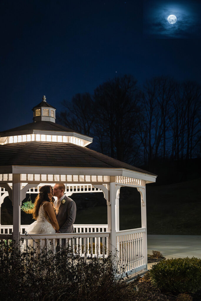 bride and groom portraits with the full moon memorial pictures in a gazebo